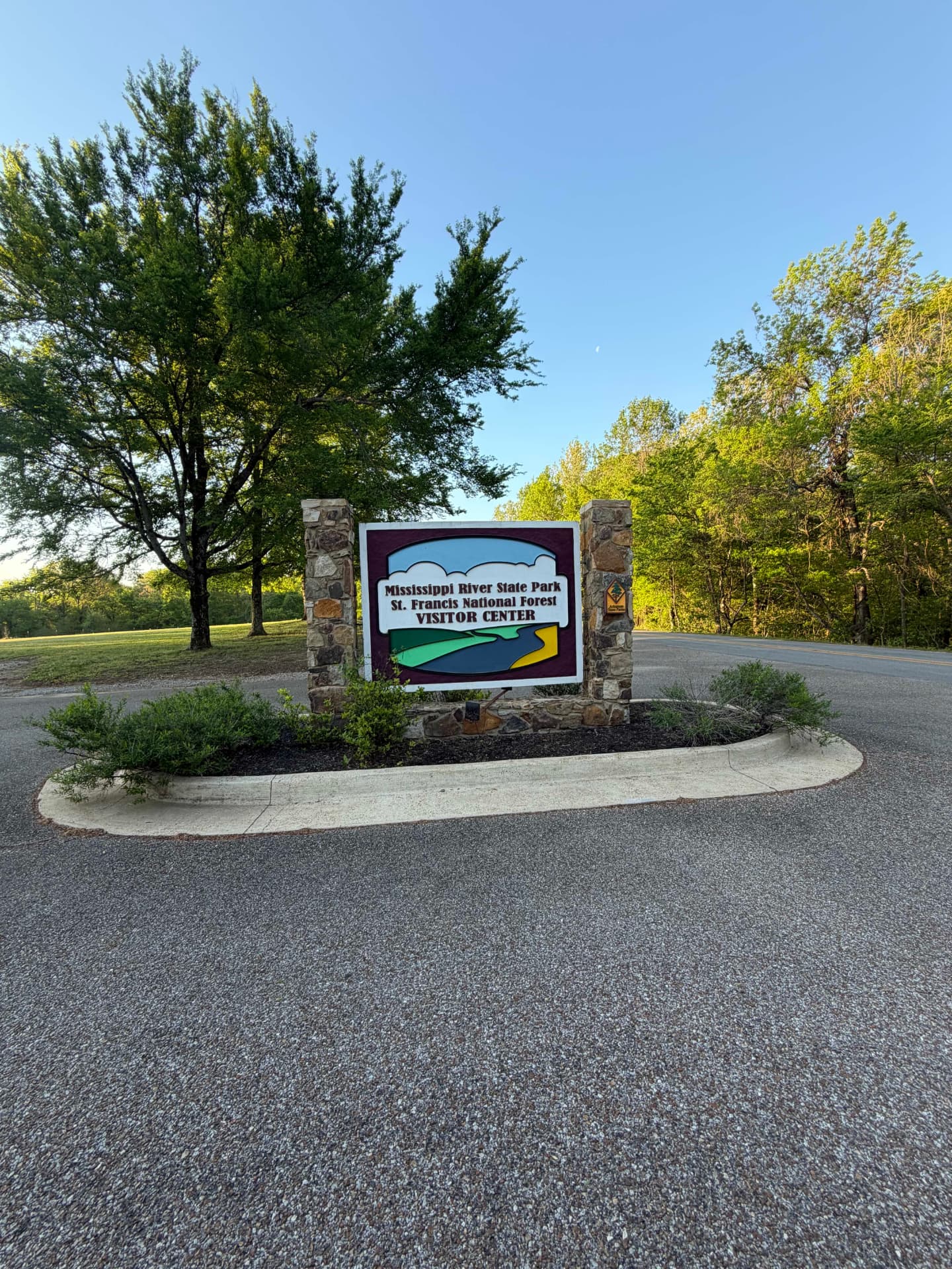 Mississippi River State Park visitor center entrance sign beneath tall trees