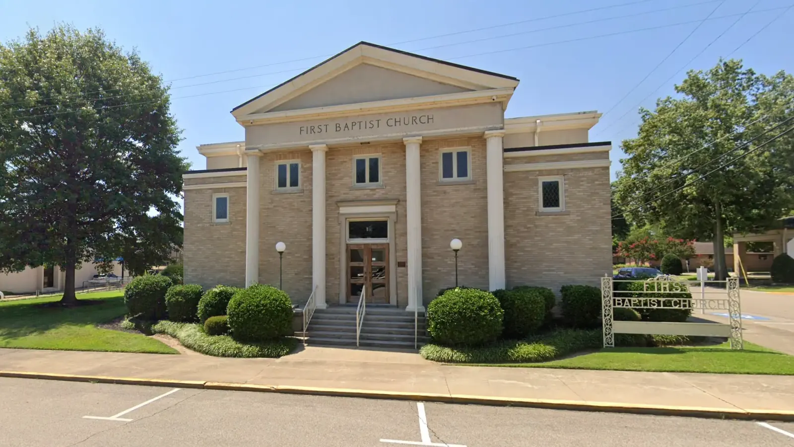 First Baptist Church in Marianna, Arkansas, with its tan brick facade, white columns and entrance steps, where riders gather for Thursday breakfast