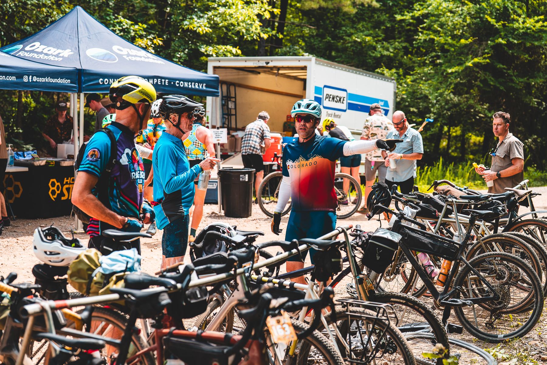 Riders refuelling at an aid station beside the support truck